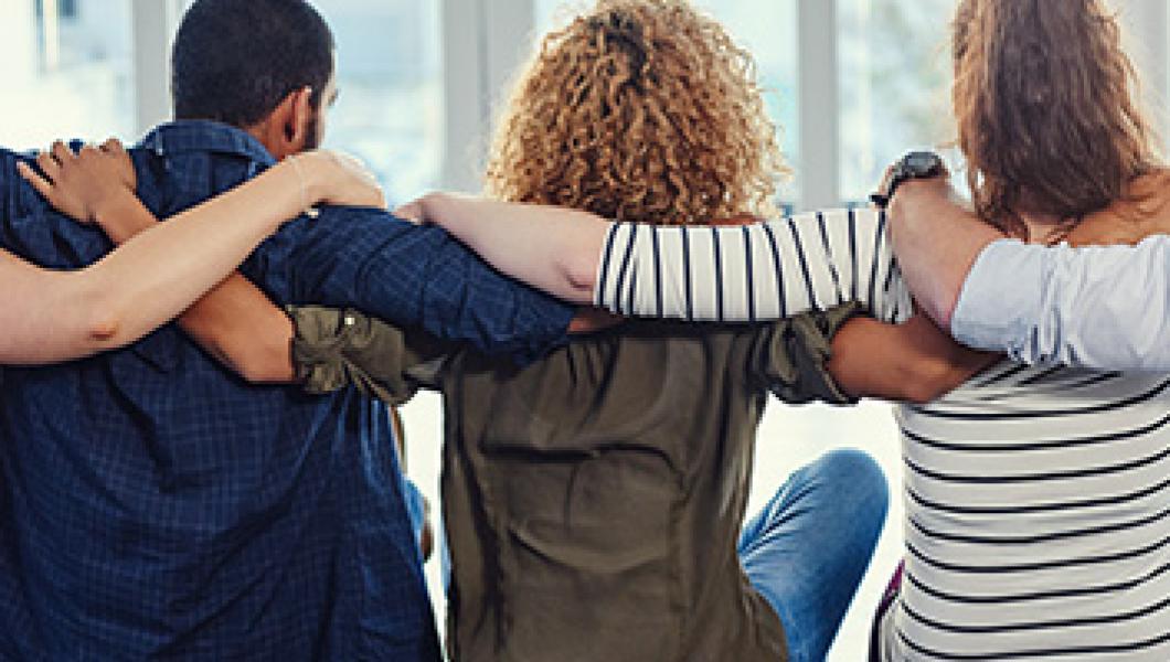 people sitting down embracing