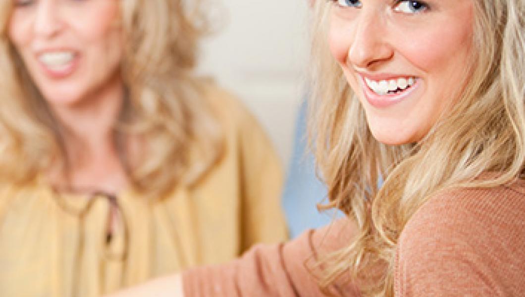 young woman smiling playing game with family