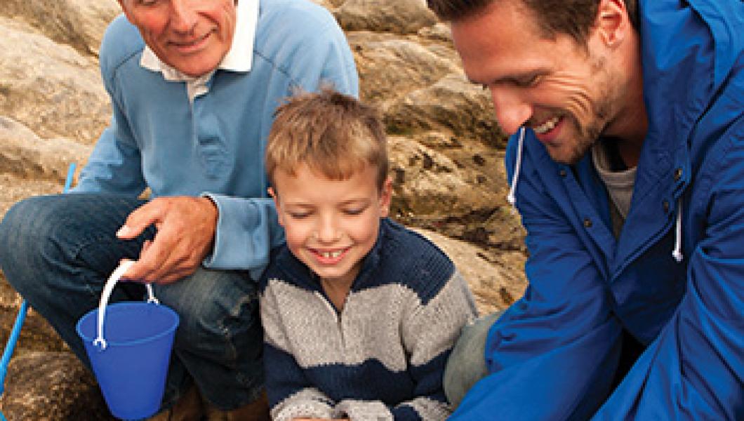 grandfather, son, and grandson catching a crab