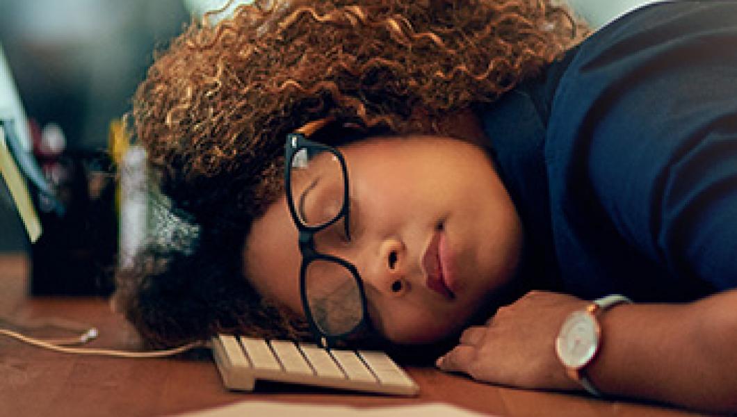 woman sleeping at desk