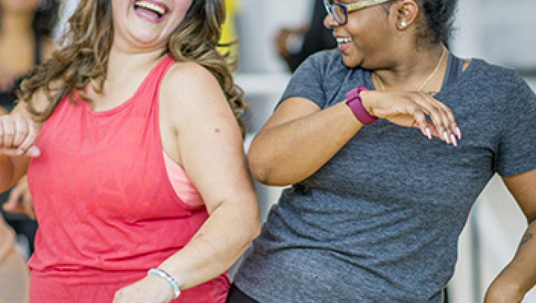 two women dancing in workout clothes