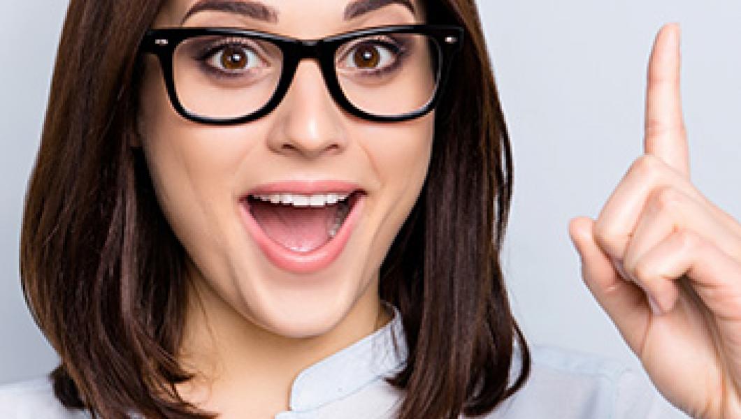 woman in glasses pointing her finger up