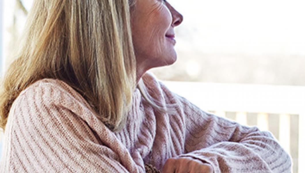 woman smiling looking out of window