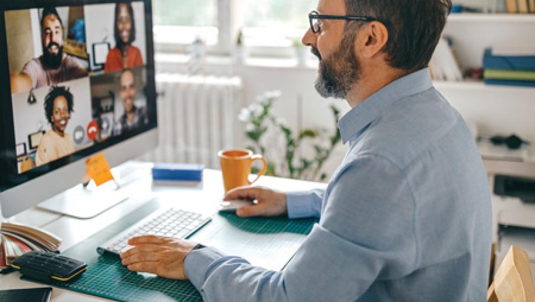 Man at desk on Zoom call