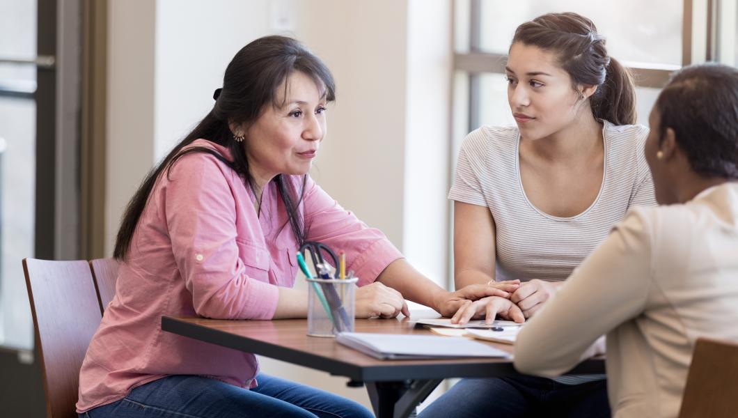 mother and daughter speaking with counselor