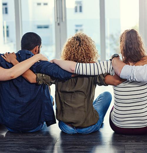 people sitting down embracing