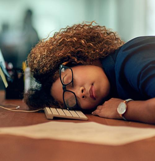 woman sleeping at desk