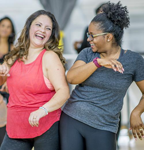 two women dancing in workout clothes