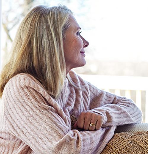 woman smiling looking out of window