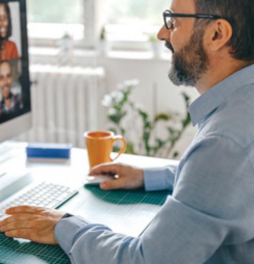 Man at desk on Zoom call