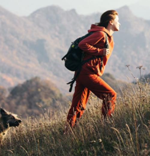 woman hiking with dog